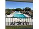 Resort-style community pools with poolside seating, lush landscaping, and a refreshing view on a sunny day at 50989 Highway 27 # 210, Davenport, FL 33897