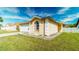 Single-story home features a well-manicured lawn, attached garage, and beautiful curb appeal at 5275 Warrior Ln, Kissimmee, FL 34746