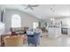 Bright open-plan living space with a kitchen island, dining area, and comfortable seating arrangement at 5275 Warrior Ln, Kissimmee, FL 34746