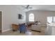 Bright open-plan living space features vaulted ceiling, large window, comfortable seating arrangement and hardwood floors at 5275 Warrior Ln, Kissimmee, FL 34746