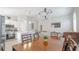 Bright open-plan living space with a kitchen island, dining area, and comfortable seating arrangement at 5275 Warrior Ln, Kissimmee, FL 34746