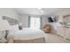 Serene bedroom with a plush king-sized bed, soft lighting, and a cozy seating area at 5275 Warrior Ln, Kissimmee, FL 34746