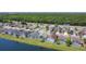 Expansive aerial view of homes with screened-in pools near a lake and bordering a large wooded area at 529 Eagle Pointe N, Kissimmee, FL 34746