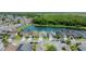 Aerial view showcases homes bordering a serene pond, surrounded by trees at 529 Eagle Pointe N, Kissimmee, FL 34746