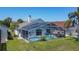 Backyard aerial view showcasing a screened pool, verdant lawn, and patio furniture at 529 Eagle Pointe N, Kissimmee, FL 34746