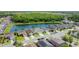 Aerial view of homes backing up to pond with lush tree line in the distance at 529 Eagle Pointe N, Kissimmee, FL 34746