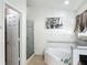 Bright bathroom featuring a corner tub, walk-in shower, and neutral-toned tile flooring at 529 Eagle Pointe N, Kissimmee, FL 34746