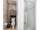 View of the bathroom featuring a toilet, wooden cabinet and enclosed shower at 529 Eagle Pointe N, Kissimmee, FL 34746