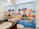 Bright bathroom with a fun Paw Patrol themed shower curtain, and vanity sink at 529 Eagle Pointe N, Kissimmee, FL 34746