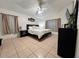 Bedroom with neutral tones, tile flooring, and a large window for natural light at 529 Eagle Pointe N, Kissimmee, FL 34746