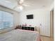 Cozy bedroom featuring a ceiling fan, large window, and playful toy storage at 529 Eagle Pointe N, Kissimmee, FL 34746
