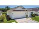 Charming home featuring an attached two-car garage and beautifully maintained landscaping at 529 Eagle Pointe N, Kissimmee, FL 34746