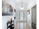 Grand foyer with high ceilings, tile flooring, art, and decorative front door with sidelights at 529 Eagle Pointe N, Kissimmee, FL 34746