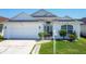 Inviting single-story home with a well-manicured lawn, attached garage, and bright exterior at 529 Eagle Pointe N, Kissimmee, FL 34746