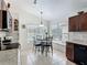 Charming breakfast nook area with tile flooring and a window view of the backyard pool at 529 Eagle Pointe N, Kissimmee, FL 34746