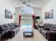 Spacious living room with tile floors, high ceilings, sliding doors to the pool area, and modern decor at 529 Eagle Pointe N, Kissimmee, FL 34746