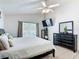 Bright bedroom featuring tile floors, ceiling fan and large windows at 529 Eagle Pointe N, Kissimmee, FL 34746