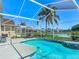 Inviting screened-in pool area with a lush green backdrop and ample seating, great for relaxation at 529 Eagle Pointe N, Kissimmee, FL 34746