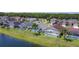 View of backyard pools in residential homes, screened in, with lake bordering backyard area at 529 Eagle Pointe N, Kissimmee, FL 34746