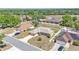 Aerial view of a single-Gathering home featuring a well-manicured lawn and a long driveway in a suburban neighborhood at 6056 Hillside Heights Dr, Lakeland, FL 33812