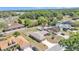Wide aerial shot showcasing the property, landscaping, and its setting among lush greenery and nearby homes at 6056 Hillside Heights Dr, Lakeland, FL 33812