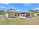 Beautiful backyard featuring a screened patio, lush lawn, and white picket fence at 6056 Hillside Heights Dr, Lakeland, FL 33812