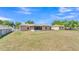 Spacious backyard with a screened patio and chainlink fence, perfect for outdoor enjoyment at 6056 Hillside Heights Dr, Lakeland, FL 33812