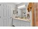 Bathroom featuring double sinks, white cabinets, and a walk-in shower at 6056 Hillside Heights Dr, Lakeland, FL 33812