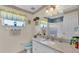 Bright bathroom featuring a vanity with granite countertop, shower and decorative accents at 6056 Hillside Heights Dr, Lakeland, FL 33812