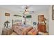 Comfortable bedroom with ceiling fan, decorative items, and ample natural light at 6056 Hillside Heights Dr, Lakeland, FL 33812