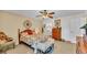 Comfortable bedroom with floral bedding, wooden furniture, and ceiling fan at 6056 Hillside Heights Dr, Lakeland, FL 33812