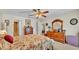 Bright bedroom featuring wooden dressers, closet, and a ceiling fan at 6056 Hillside Heights Dr, Lakeland, FL 33812