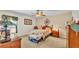Cozy bedroom featuring a floral bedspread, ceiling fan, and natural light at 6056 Hillside Heights Dr, Lakeland, FL 33812