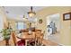 Charming dining room open to living area with a round table and decorative light fixture at 6056 Hillside Heights Dr, Lakeland, FL 33812