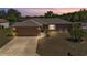 Inviting home exterior with a well-maintained lawn, garden, and attached two-car garage at 6056 Hillside Heights Dr, Lakeland, FL 33812