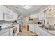 Bright kitchen with white cabinets, stainless steel appliances, and tile flooring at 6056 Hillside Heights Dr, Lakeland, FL 33812