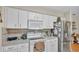 Clean kitchen featuring white cabinets, stainless steel fridge, and modern appliances at 6056 Hillside Heights Dr, Lakeland, FL 33812