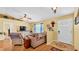 Cozy living room featuring wood floors, comfortable seating, and lots of natural light at 6056 Hillside Heights Dr, Lakeland, FL 33812