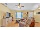 Comfortable living room featuring wood floors, ceiling fan, and bright natural light at 6056 Hillside Heights Dr, Lakeland, FL 33812