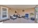 Cozy screened-in patio with comfortable seating and a charming view of the yard at 6056 Hillside Heights Dr, Lakeland, FL 33812
