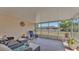 Relaxing screened patio with wicker furniture, plants, and view of the backyard at 6056 Hillside Heights Dr, Lakeland, FL 33812
