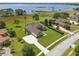Aerial view of a well-maintained home with lush lawn, long driveway and manicured landscaping at 6132 Waterfield Way, St Cloud, FL 34771