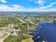 Stunning aerial view of a lakeside community with docks, lush greenery, and pristine lakes under a bright blue sky at 6132 Waterfield Way, St Cloud, FL 34771