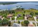 Aerial view of the sprawling property featuring a large home, mature trees, and waterfront access at 6132 Waterfield Way, St Cloud, FL 34771