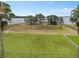 Expansive backyard featuring manicured lawn, waterfront views, and fenced perimeter at 6132 Waterfield Way, St Cloud, FL 34771