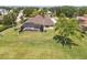 Aerial view of backyard with a screened-in pool and lush, green lawn at 6132 Waterfield Way, St Cloud, FL 34771