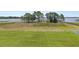 Spacious backyard with manicured lawn leading to waterfront and dock at 6132 Waterfield Way, St Cloud, FL 34771