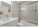 Bathroom with tiled floors, a shower with glass sliding doors, a toilet, and a modern sink vanity with a large mirror at 6132 Waterfield Way, St Cloud, FL 34771