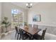 Bright dining room featuring a large window and a modern chandelier at 6132 Waterfield Way, St Cloud, FL 34771