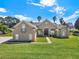 A beautiful single-story home featuring a lush lawn and mature landscaping at 6132 Waterfield Way, St Cloud, FL 34771